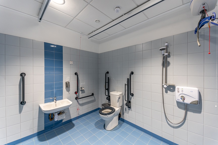 Picture of peninsular toilet, sink and shower in Changing Places toilet facility